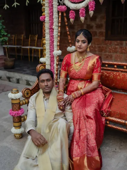 A classic portrait of the groom in his traditional wedding attire, set against the charming backdrop of a heritage venue.