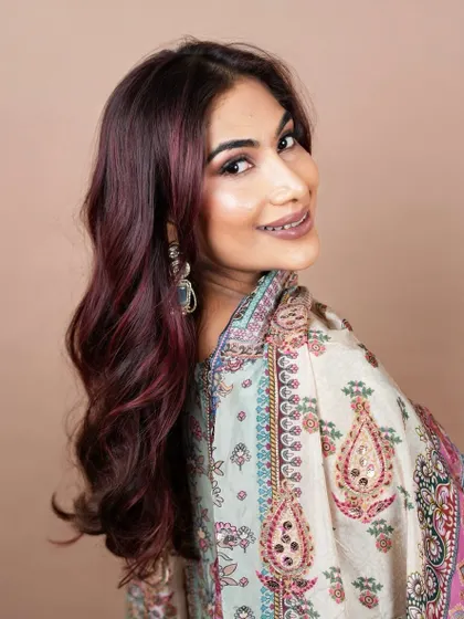 Stardust tangled in ruby waves. This portrait showcases the beautiful red tones against a traditional Indian outfit, proving that bold color can be incredibly elegant.