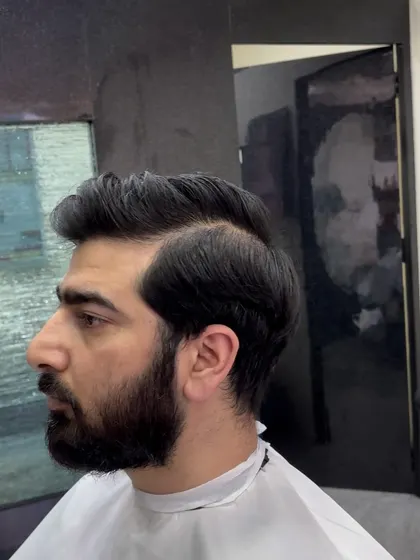 A traditional gentleman's haircut with a side part and natural volume. This is a clean, professional look that is always appropriate.