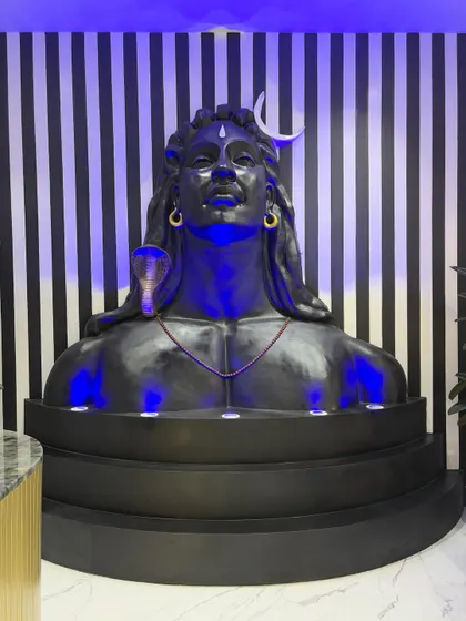 The Shiv mural fully installed and illuminated with custom blue lighting. This view shows how the sculpture commands the space and sets a devotional, inspiring tone.