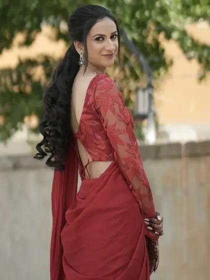 A modern take on saree styling for a party. I created a voluminous ponytail with soft waves and makeup that enhances her features for a chic, backless blouse look.