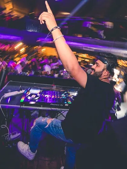 A dynamic, blurry shot of me reaching for the sky, capturing the motion and energy of the night.