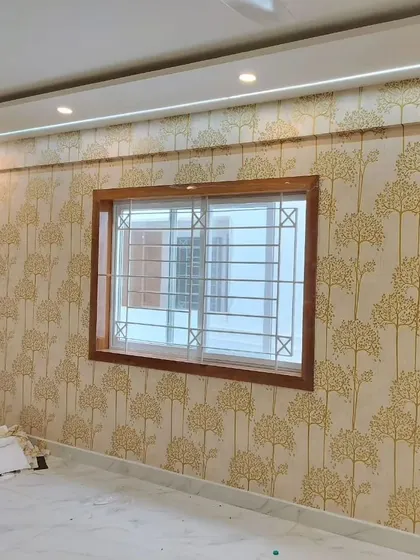 A living room with a tree pattern wallpaper, showing how it looks in a larger space with natural light.