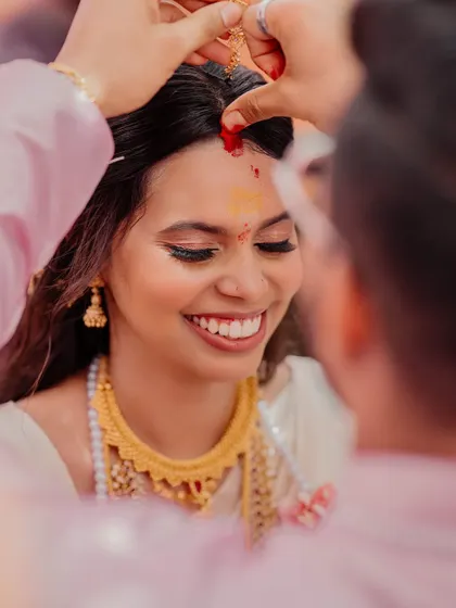 A precious moment during the ceremony. The close-up shows her flawless skin and the genuine happiness that makes any bridal look complete.