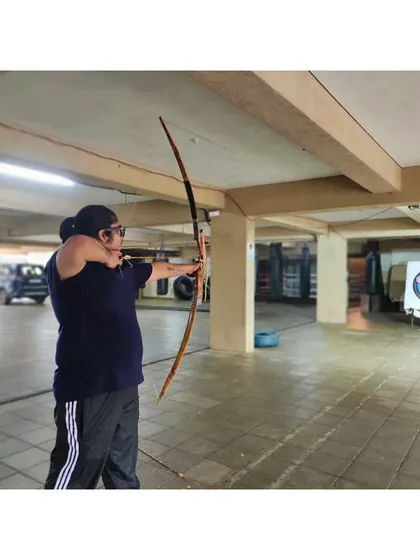 A student takes aim, showing the correct anchor point and posture. These are the details that make a big difference.