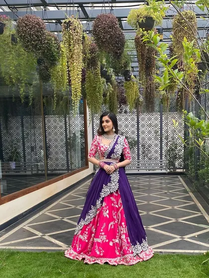 A beautiful lehenga in shades of pink and purple. The makeup is soft and romantic to match the floral embroidery of the outfit.