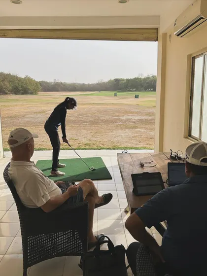 Analyzing a player's swing with other coaches during the camp. A collaborative approach benefits everyone.