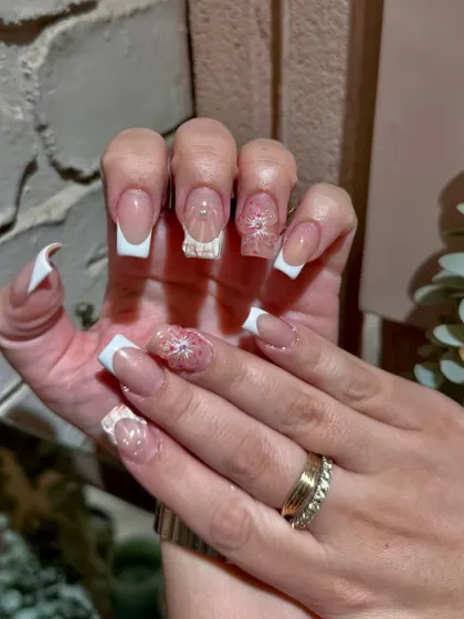 A stunning example of 3D floral art on a classic square French tip. This is how we elevate a timeless look for a modern bride or special event.