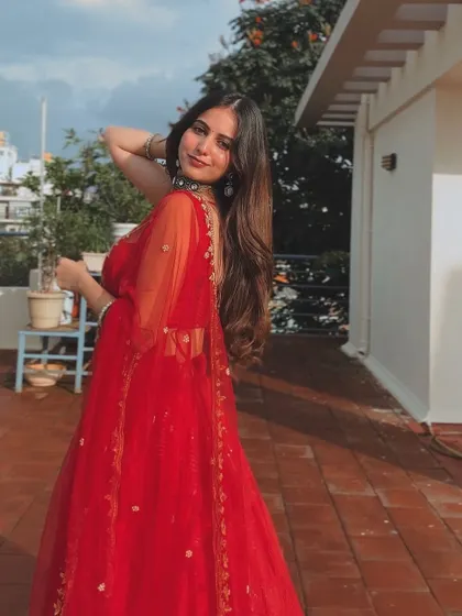 A final, happy shot of the client in her custom red lehenga.