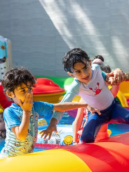 A candid shot of boys playing on the inflatable water course. It's all about action and adventure.