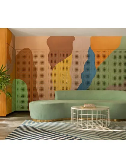 This view of the waiting area shows how we used a bold, striped rug to anchor the space and complement the colorful wall mural. The design is a joyful blend of pattern and color, designed to uplift and inspire.