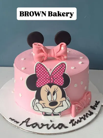 A sweet Minnie Mouse cake for Aaria's first birthday. This is a vegan fruit-flavored cake, showing that we can accommodate dietary needs without sacrificing a fun design.