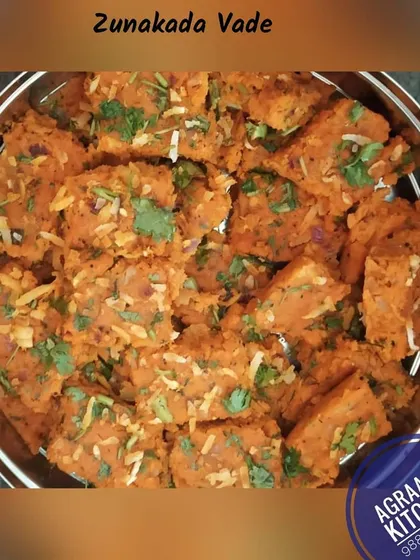 Zunakada Vade, a savory cake made from gram flour and spices, is a North Karnataka delicacy. It's soft, flavorful, and garnished with fresh coriander and coconut.