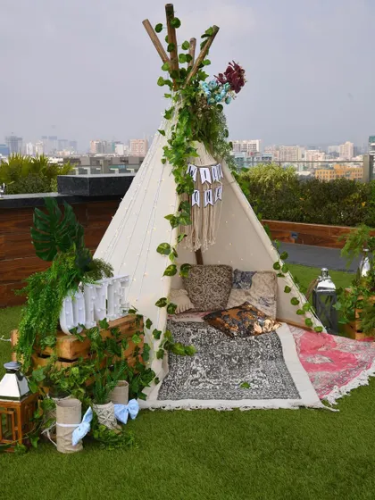 A closer view of the teepee, styled with printed rugs, cushions, and lanterns to create a cozy and picture-perfect nook for the little one and guests.