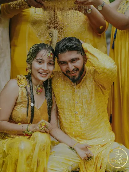A happy, candid shot of the couple after being drenched during their Haldi rituals.