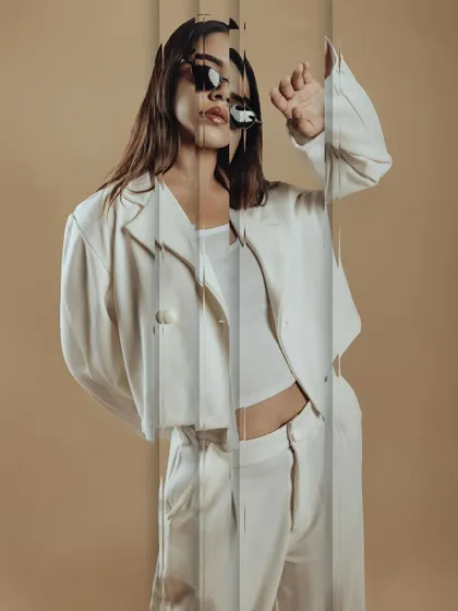 An experimental shot using reflections. The makeup remains a key part of the overall artistic vision, holding its own even with creative photo effects.