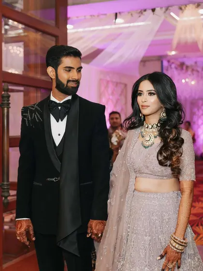 A reception bride and groom. Her look is soft and romantic, with a focus on a flawless base and gently defined eyes.