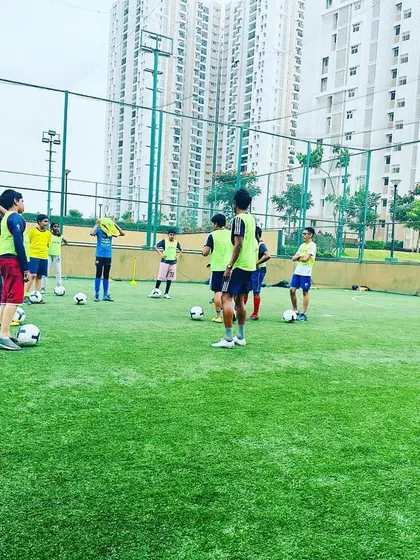 Players listen to their coach at our Prestige Falcon City center. We bring quality coaching to gated communities.