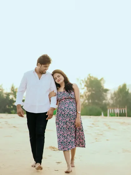 A peaceful walk on the beach at sunset. The warm light and her gentle lean on his shoulder make this a very sweet and romantic shot.