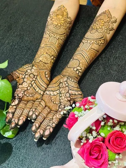 A full view of a stunning pre-engagement mehendi. The design is dense with paisleys and florals, offering a classic bridal feel that is both elegant and timeless.