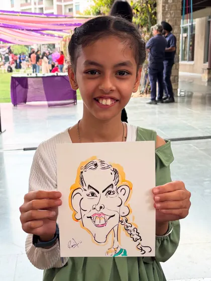 A young girl with a bright smile, delighted by her fun caricature.