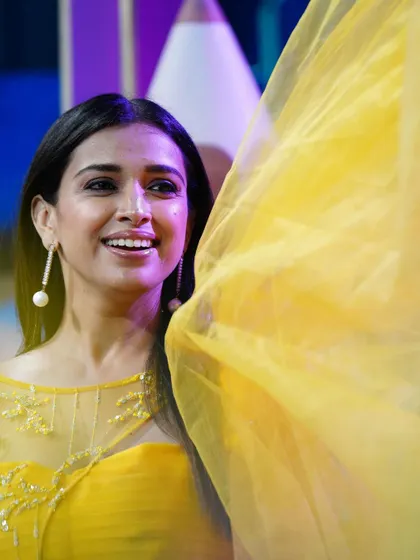 The lovely Shwetha Changappa smiling in a custom bright yellow gown I designed for her.