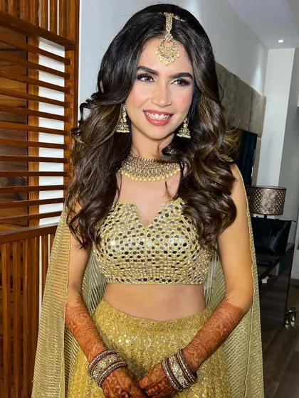 The full Sangeet look, showing how the makeup and hair complement the festive and glamorous outfit.