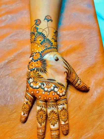 We also experiment with color. This unique design incorporates hints of blue, adding a modern and playful twist to the traditional henna art.