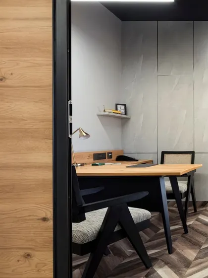 A view into one of the director's cabins at Aromasphere. The chevron wood flooring and custom desk are complemented by our modern interpretation of the iconic Pierre Jeanneret chair, creating a space of understated authority.
