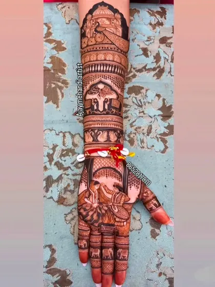 A full-arm design showcasing a variety of traditional elements, including elephants, swans, and a doli scene, all tied together with intricate linework.