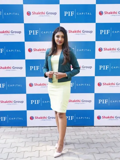 A full-length shot against the PIF Capital media wall.