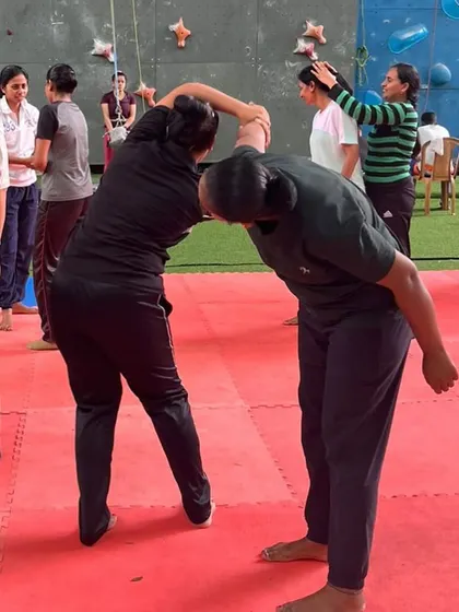 Partner drills are essential for learning how to react to an opponent. In this image, participants practice escaping a hold, learning to use leverage and body mechanics to break free from a stronger grip.