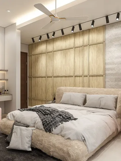 We designed this cozy bedroom to be highly functional. It features a full-wall wooden wardrobe, a floating study desk with overhead storage, and a dedicated dressing table next to the bed.