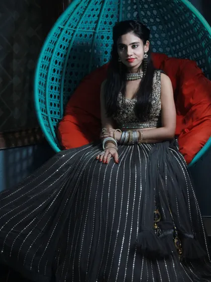 This black lehenga with vertical silver stripes and a heavily embroidered blouse is a modern and stylish option for any party.