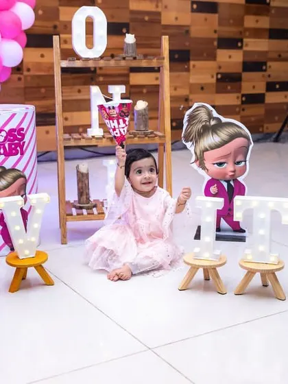 The star of the show. A beautiful portrait of the birthday girl amidst her 'Boss Baby' themed party decorations.