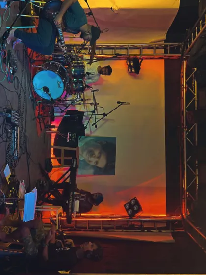 An artistic shot of the stage setup from the side, showing the drums and lighting rig before the KK tribute show.