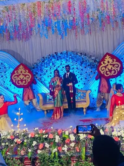 A Diya entry combined with fog effects and other props creates a multi-layered, visually rich welcome for the bride and groom on their reception stage.