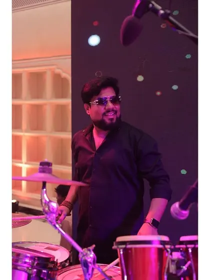 Our drummer, keeping the rhythm tight and driving the energy forward. He's the powerhouse behind our live band sound.