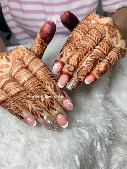 Another perspective of the soft gel extensions with French tips and floral art. This angle highlights the clean lines and the subtle elegance of the design, perfect for a bride who wants a sophisticated look.
