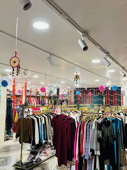 Another view of the store, showing the decorated checkout counter and the colorful paper hangings.