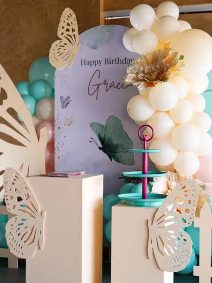 Another perspective of the butterfly first birthday setup, showing the beautiful layering of colors and textures. The teal dessert stand adds a perfect pop of contrasting color.
