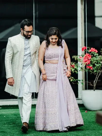 A candid shot of a couple walking together on their engagement day, sharing a private moment.