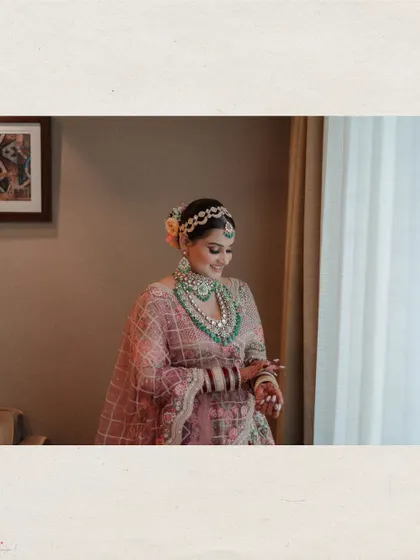 The bride looking out a window, captured in a quiet, candid moment.
