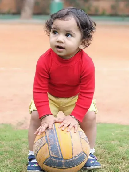 An outdoor session at the playground is a perfect way to capture a child's natural energy. This little one was completely absorbed with his ball, creating a perfect candid moment.