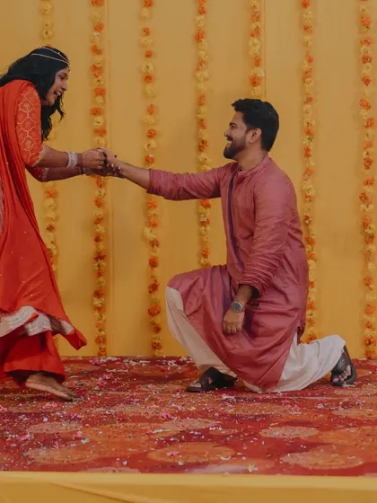 The groom gets down on one knee again, this time during a fun dance sequence. These moments of spontaneous romance are what make a celebration special.