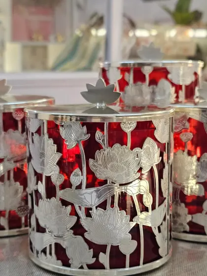 A closer look at the intricate floral metalwork on these premium red and silver jars, designed to be a treasured keepsake.