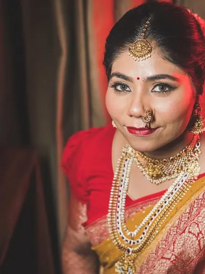 A beautiful indoor portrait of the bride, Pragya, in her traditional South Indian wedding saree.