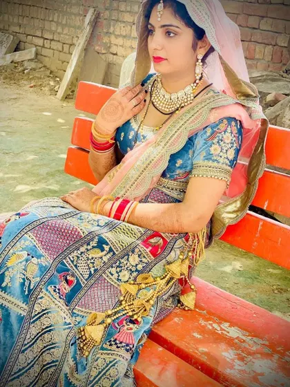 A side profile showcasing the beautiful embroidery on the blouse and the traditional latkans on this unique story-telling lehenga.