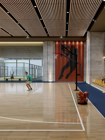 A wider view of the sports club, showing the basketball court alongside a paddle tennis court. These facilities are part of a comprehensive offering designed to elevate the standard of sports and recreation for residents.
