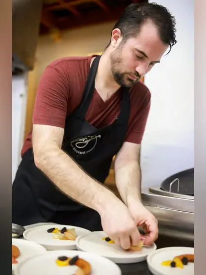 Serving culinary excellence with every bite. Here I am, carefully plating dishes for a private catering event, ensuring each one is perfect.